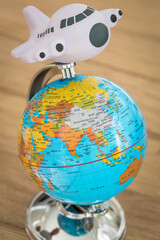Fototapete - Globe and a toy plane,  Concept for traveling around the world