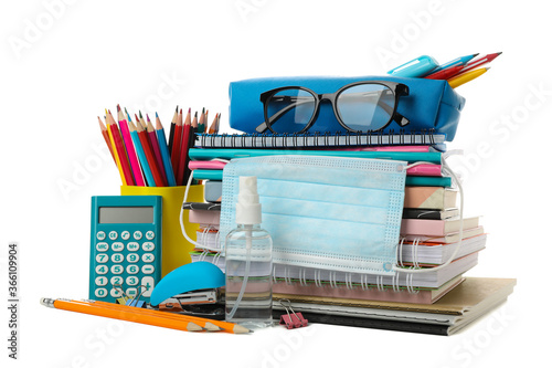 School supplies with medical mask and sanitizer isolated on white background