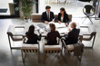 © Maskot - High angle view of financial advisors and customers discussing during meeting at law firm