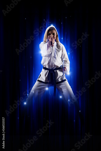 Woman in kimono practicing taekwondo Fototapet