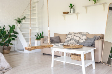 Luxury bedroom design in a rustic cottage in a minimalist style. white walls, panoramic windows, wooden elements of decoration on the ceiling, rope swings in the middle of a spacious room