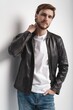Fashion man, Handsome serious beauty male model portrait wear leather jacket, young guy over white background