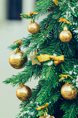 Wall Mural - Green fir tree with golden balls. Christmas wallpaper.