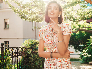 Portrait of young beautiful smiling  woman in trendy summer sundress.Sexy carefree woman posing on the street background at sunset. Positive model outdoors