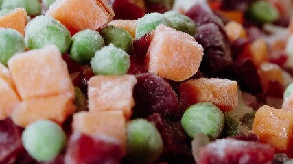 Wall Mural - Raw frozen food for a vegan dinner. Close-up of mixed frozen vegetables. Top view.