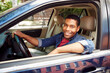 © Tetra Images - Smiling man posing in car window