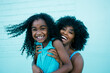 © Tetra Images - Portrait of Black mother and daughter laughing
