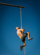 © Erik Isakson/Tetra Images - Man climbing on rope