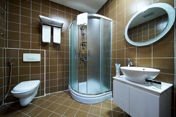 Interior of brown bathroom with bathtub, sink and toilet