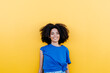© VISTA by Westend61 - Pretty woman standing in front of yellow wall, smiling happily
