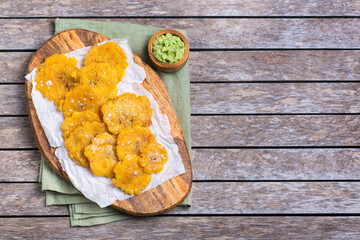 Fried tostones, green plantains, bananas with guacamole sauce