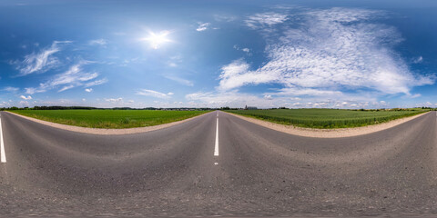 Wall Mural - Full spherical seamless hdri panorama 360 degrees angle view on no traffic asphalt road among fields with cloudy sky in equirectangular projection, VR AR content