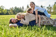 © Westend61 - Happy family lying on grass during sunny day