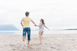 © Westend61 - Happy couple running hand in hand on the beach, Sardinia, Italy