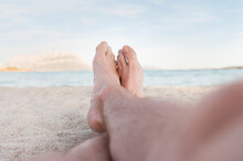 Man's Sandy Feet On The Beach,  Sardinia, Italy