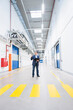 © Westend61 - Businessman holding folder on factory corridor