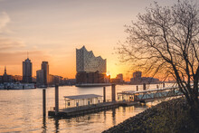 Germany, Hamburg,ÔøΩEmpty Harbor On Bank Of Elbe River At Sunrise WithÔøΩElbphilharmonie In Background