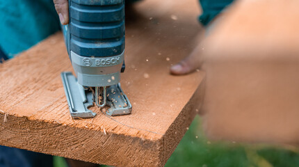 Carpenter sawing wood 