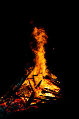 Bonfire that burns on a dark background, wood burning flame.