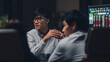 © tirachard - Asia businessmen and businesswomen meeting brainstorming ideas conducting business presentation project colleagues working together plan success strategy enjoy teamwork in small modern night office.