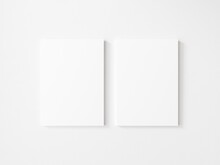 Two Empty Vertical Canvas Frame On White Wall. 3d Illustration.