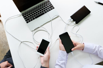 people using power bank charge to mobile phone. Tech Device Charge Sharing Concept.