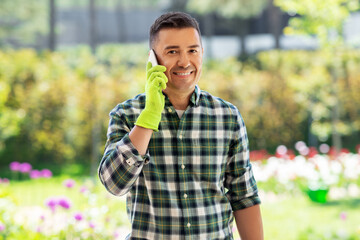 Canvas Print - gardening, communication and people concept - happy smiling middle-aged man calling on smartphone at summer garden