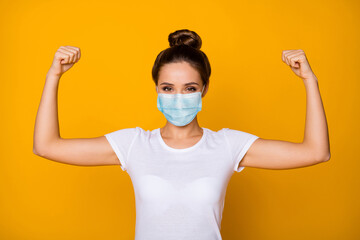 Sticker - Close-up portrait of her she nice attractive pretty girl wearing safety gauze mask demonstrating biceps muscles stop viral pneumonia mers cov influenza isolated vibrant yellow color background