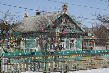 Wooden house with ornamental carved windows, frames in village in Sergiyevo-Posadsky district, Russia. Russian traditional national folk style in architecture