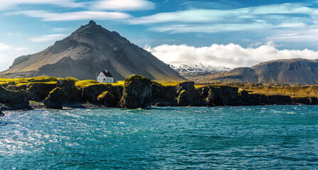 Panoramic view on Impressive Icelandic seascape. Majestic view on famous Arnarstapi village of sunny day. Saefellsnes peninsula. Amazing nature of Iceland. popular travel and hiking destination place