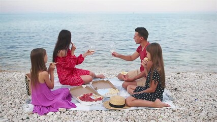 Wall Mural - Family having a picnic on the beach