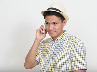 Wall Mural - Portrait of handsome Asian tourist man talking on the phone