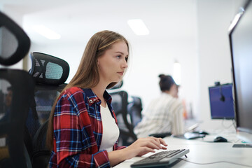 Wall Mural - casual business woman working on desktop computer