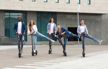 Friends having fun riding motorized kick scooters