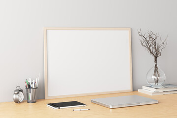 Wall Mural - Horizontal poster frame mockup on the wooden table of home studio workspace with white wall. Side view, clipping path around poster picture.