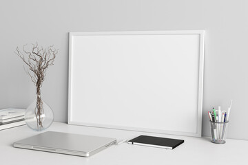 Wall Mural - Horizontal poster frame mockup on the white table of home studio workspace with white wall. Side view, clipping path around poster picture.