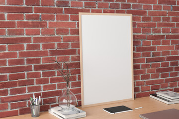 Sticker - Vertical poster frame mockup on the wooden table of home studio workspace with red brick wall. Side view, clipping path around poster picture.