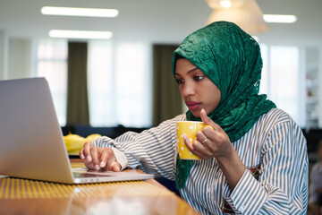 Wall Mural - african muslim business woman drinking tea