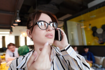 Wall Mural - portrait of businesswoman with glasses using mobile phone