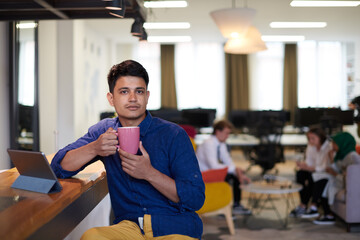 Wall Mural - casual indian business man taking break from the work