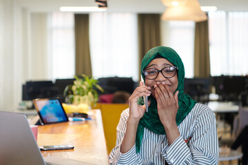 Wall Mural - african muslim business woman using mobile phone