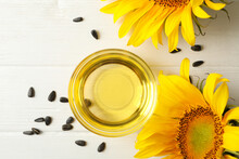 Sunflower, Seeds And Oil On White Wooden Background