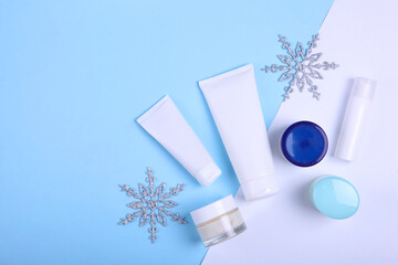 Wall Mural - Winter care cosmetics on a colored background top view, place to insert text, minimalism. Skin care, skin hydration
