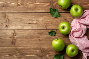 Fresh green apples on rustic wooden background