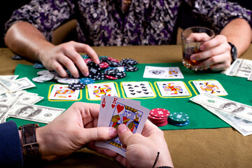 cards in male hands with a clock on the background