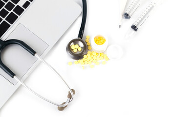 White tablet, laptop and doctor tools isolated on white background