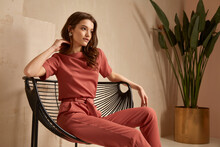 Beautiful Brunette Woman Natural Makeup Wear Fashion Clothes Casual Dress Code Office Style Total Pink Blouse And Pants Suit, Romantic Date Business Meeting Armchair Interior Stairs Flowerpot.