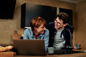 Couple using a laptop at home