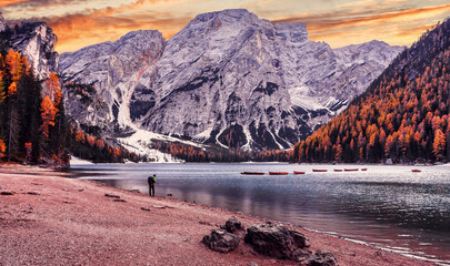 Fototapete - Wonderful sunrise view of Braies lake. Dramatic Unusual Scene. Colorful Sky over lago di Braies in Dolomites Alps. Awesome Alpine Highlands during sunset. Amazing nature Landscape at Autumn Day.