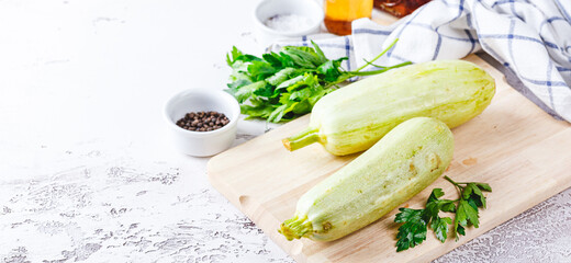 Sticker - Fresh zucchini on a wooden board with a knife